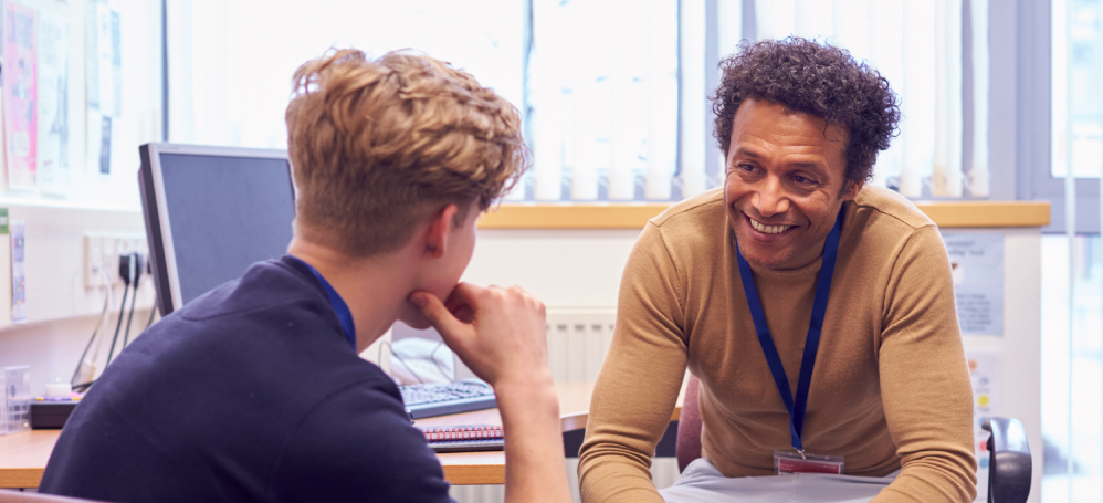 A speech counselor meeting with a client with laptop in the background.